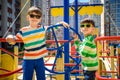 Two brothers sibling boy as a captain or sailors play on the ship outdoors on sunny day. Kids has a lot of fun. Ship has colorful Royalty Free Stock Photo