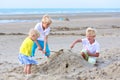 Two brothers and sister playing on the beach Royalty Free Stock Photo
