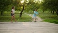 Two brothers and sister walking in park. Kids playing with frisbee outdoors Royalty Free Stock Photo