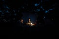 Two brothers sitting by a tent with a dimmed light Royalty Free Stock Photo