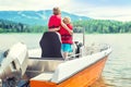 Two brothers swim on a motor boat on the lake. Royalty Free Stock Photo