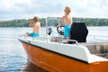 Two brothers swim on a motor boat on the lake. Royalty Free Stock Photo
