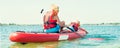 Two brothers swimming on stand up paddle board.Water sports , active lifestyle.