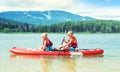 Two brothers swimming on stand up paddle board.Water sports , active lifestyle.