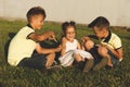 Two brothers tickle their sister in nature. horizontal frame Royalty Free Stock Photo