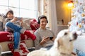 Two brothers using gaming devices on Christmas Eve