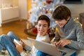 Two Boys Using Laptop by Christmas Tree Royalty Free Stock Photo