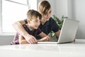 Two brothers using laptop computer to do their homework Royalty Free Stock Photo