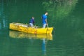 Two brothers young boy and a small child fishing alone with th