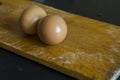 Two brown boiled chicken eggs on the chopping board