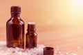 Two brown bottle for essential oil in sea salt, aromatherapy and spa concept with copy space Royalty Free Stock Photo