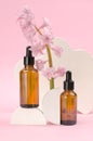 Two brown bottles with a dropper with essential oils or serum with hyacinth flowers. Care and beauty concept