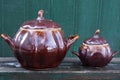 Two brown ceramic pots covered with lids on a table Royalty Free Stock Photo