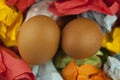 Two brown Easter eggs on crumpled colorful paper. Close-up. Sweet easter concept. Healthy food. Flat lay, top view Royalty Free Stock Photo