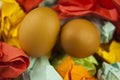 Two brown Easter eggs on crumpled colorful paper. Close-up. Sweet easter concept. Healthy food. Flat lay, top view Royalty Free Stock Photo