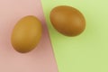 Two brown Easter eggs on crumpled colorful paper. Close-up. Sweet easter concept. Healthy food. Flat lay, top view Royalty Free Stock Photo