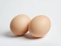 Two brown eggs sit next to each other on a white background Royalty Free Stock Photo
