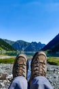 Two brown female boots near Gaube Lake, Lac de Gaube, in the Pyrenees mountains, mountain range between Spain and France Royalty Free Stock Photo