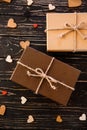 Two brown gift boxes on a wooden background with a bow of a simple rope on wood backgraund