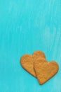 Two Brown Ginger Cookies in Heart Shape on Light Blue Background Corner Position. Valentine Romantic