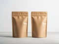 Two brown kraft paper bags with metalized finish on a white surface Royalty Free Stock Photo