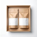 Two Brown Kraft Paper Pouches in Open Cardboard Box on White Backdrop Royalty Free Stock Photo