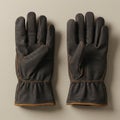 Two brown leather gloves are displayed side by side on a beige textured background. Royalty Free Stock Photo