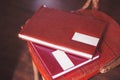 Two brown leather wedding photo album with engraving on the cover lie on a wooden table. Soft focus. Royalty Free Stock Photo