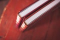 Two brown leather wedding photo album with engraving on the cover lie on a wooden table. Soft focus. Royalty Free Stock Photo