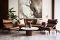 Two brown lounge chairs against white sofa and round coffee tables. Mid-century home interior design of room with marble wall Royalty Free Stock Photo