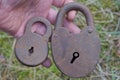 two brown old rusty iron padlocks lie on the palm Royalty Free Stock Photo