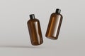 Two brown plastic cosmetic containers, shampoo bottles floating on gray background front view 3D render mockup