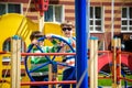Two brothers sibling boy as a captain or sailors play on the ship outdoors on sunny day. Kids has a lot of fun. Ship has colorful Royalty Free Stock Photo