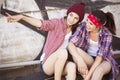 Two Brunette teenage girls friends in hipster outfit jeans shor Royalty Free Stock Photo