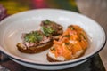 Two bruschetta on a white plate in a restaurant. Royalty Free Stock Photo