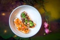 Two bruschetta on a white plate in a restaurant. Royalty Free Stock Photo