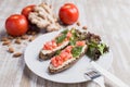 Two bruschettas, almonds, ginger and tomatoes