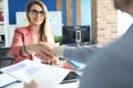 Two buainess people shake hand against office background Royalty Free Stock Photo