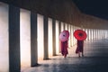 Two buddhist monk novice holding red umbrellas and walking in pagoda, Myanmar Royalty Free Stock Photo