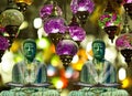 Two buddhist monk statues meditating holding burning incense with lanterns on the background