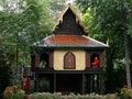 Two Buddhist monks in an old traditional teak wood house in the gardens of the Suan Pakkad Palace Museum in Bangkok, Thailand