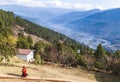 Two Buddhist monks in their traditional red clothes on the territory of women Buddhist Monastery in Bhutan, Punakha valley on the