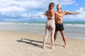 Two buddy doing body stretching exercises outdoor on summer tropical island beach with blue sea, couple doing exercise outdoor, Royalty Free Stock Photo