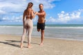Two buddy doing body stretching exercises outdoor on summer tropical island beach with blue sea, couple doing exercise outdoor, Royalty Free Stock Photo