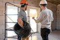 Two builders look at the drawing of the object Royalty Free Stock Photo