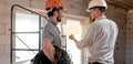 Two builders look at the drawing of the object Royalty Free Stock Photo
