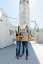 Two builders checking something outdoors