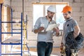 Two builders collaborate to build a new home Royalty Free Stock Photo