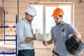 Two builders collaborate to build a new home Royalty Free Stock Photo
