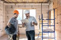 Two builders collaborate to build a new home Royalty Free Stock Photo